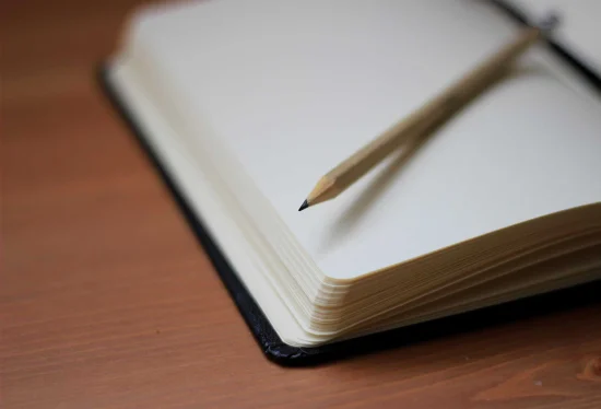 Notebook and pencil representing reflection and therapeutic exploration